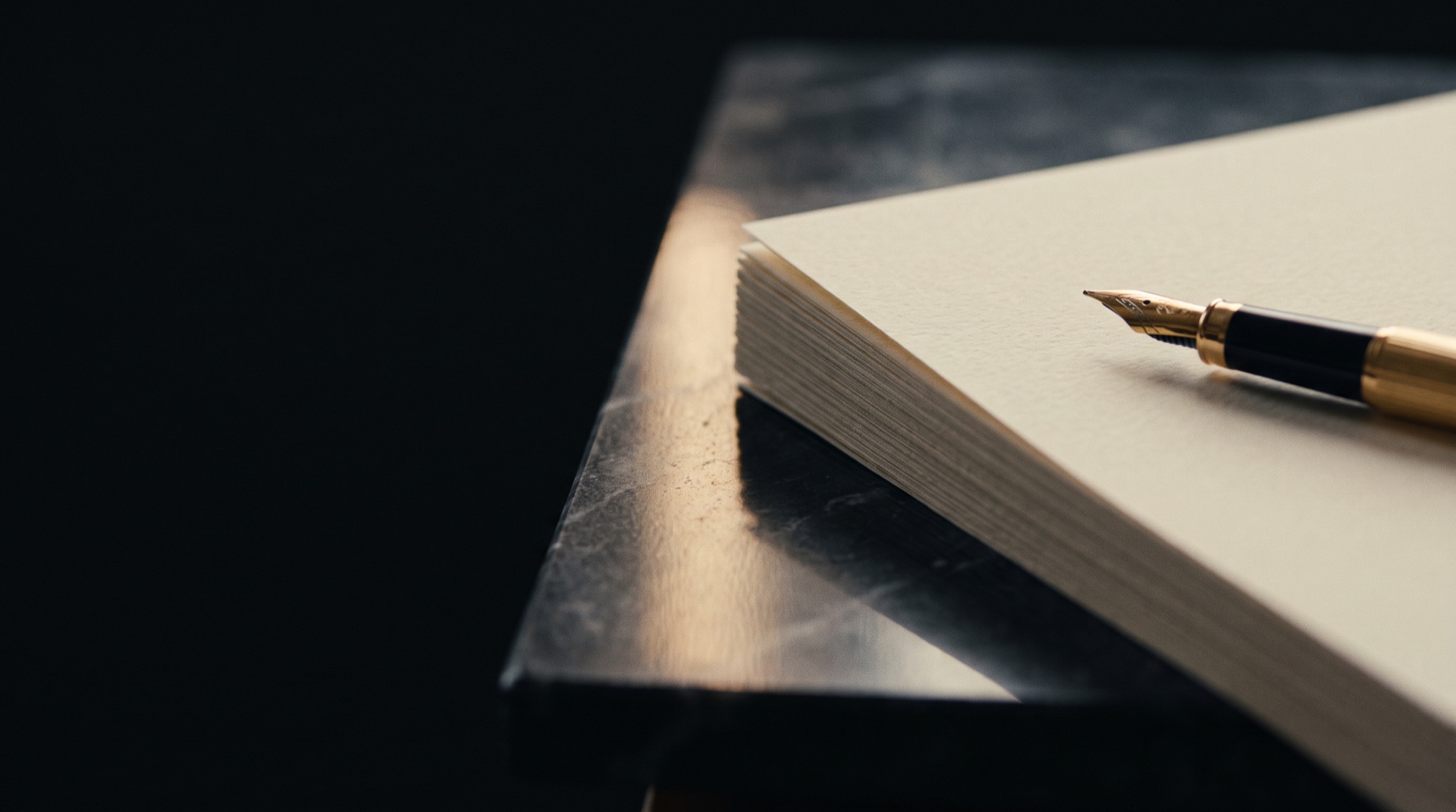 A private study at night, papers and a gold pen under warm lamplight.